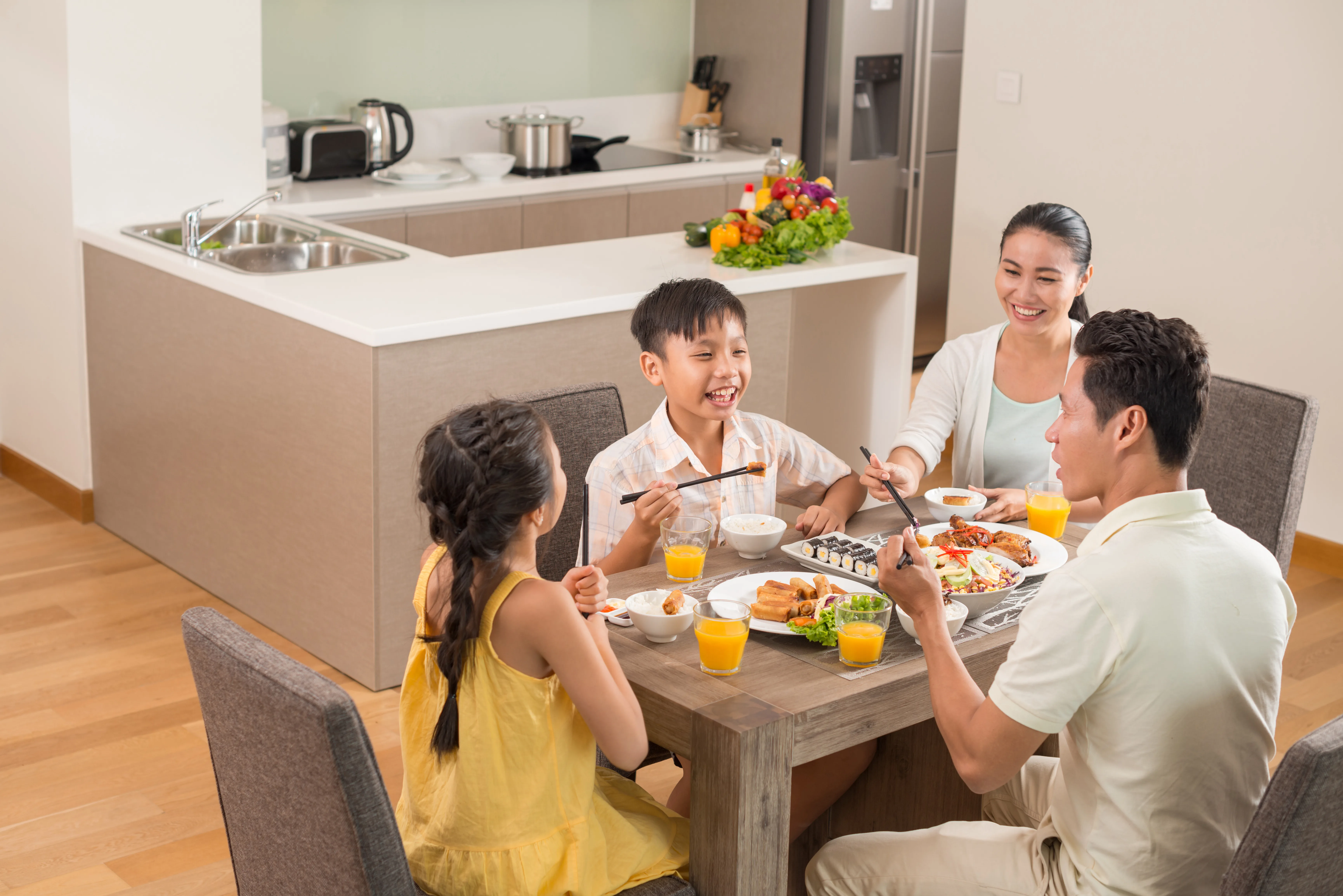 A family eating breakfast together at a kitchen counter